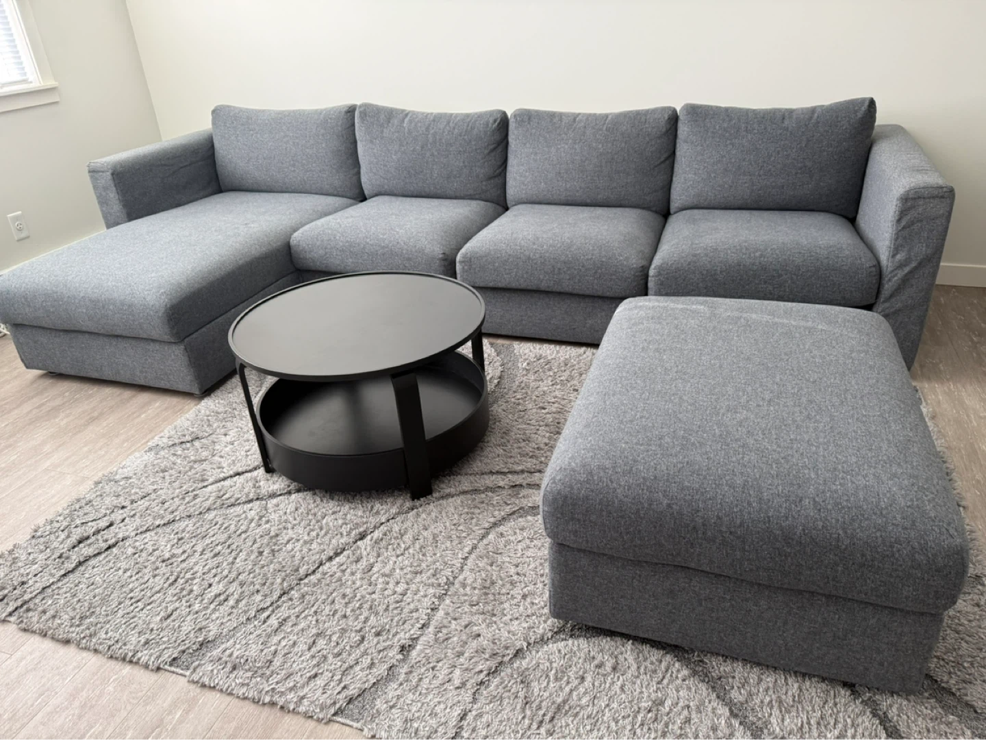 Grey Sectional Sofa with Ottoman, coffee table and area rug