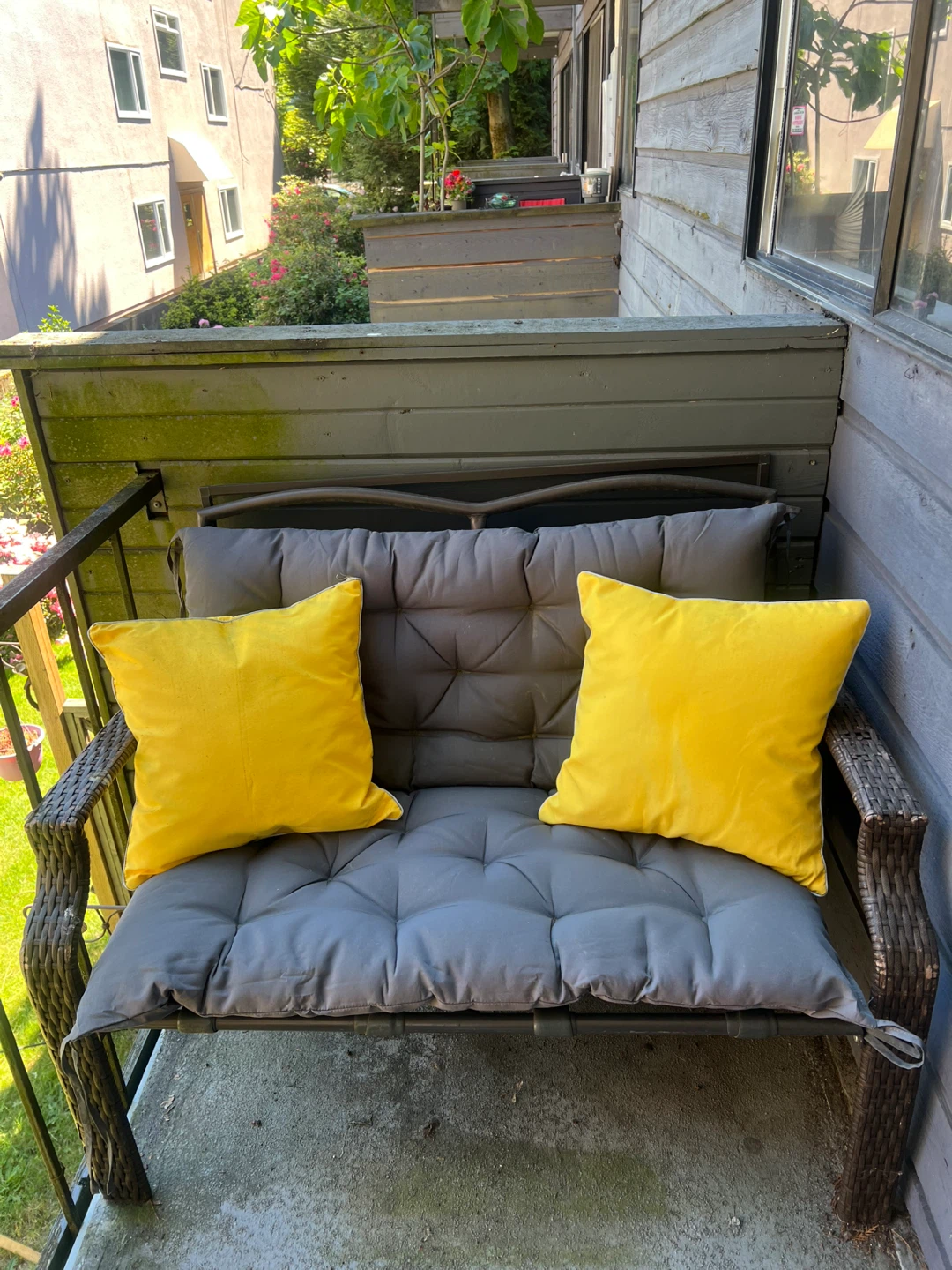 Outdoor Patio Bench with Grey Cushions and Yellow Pillows