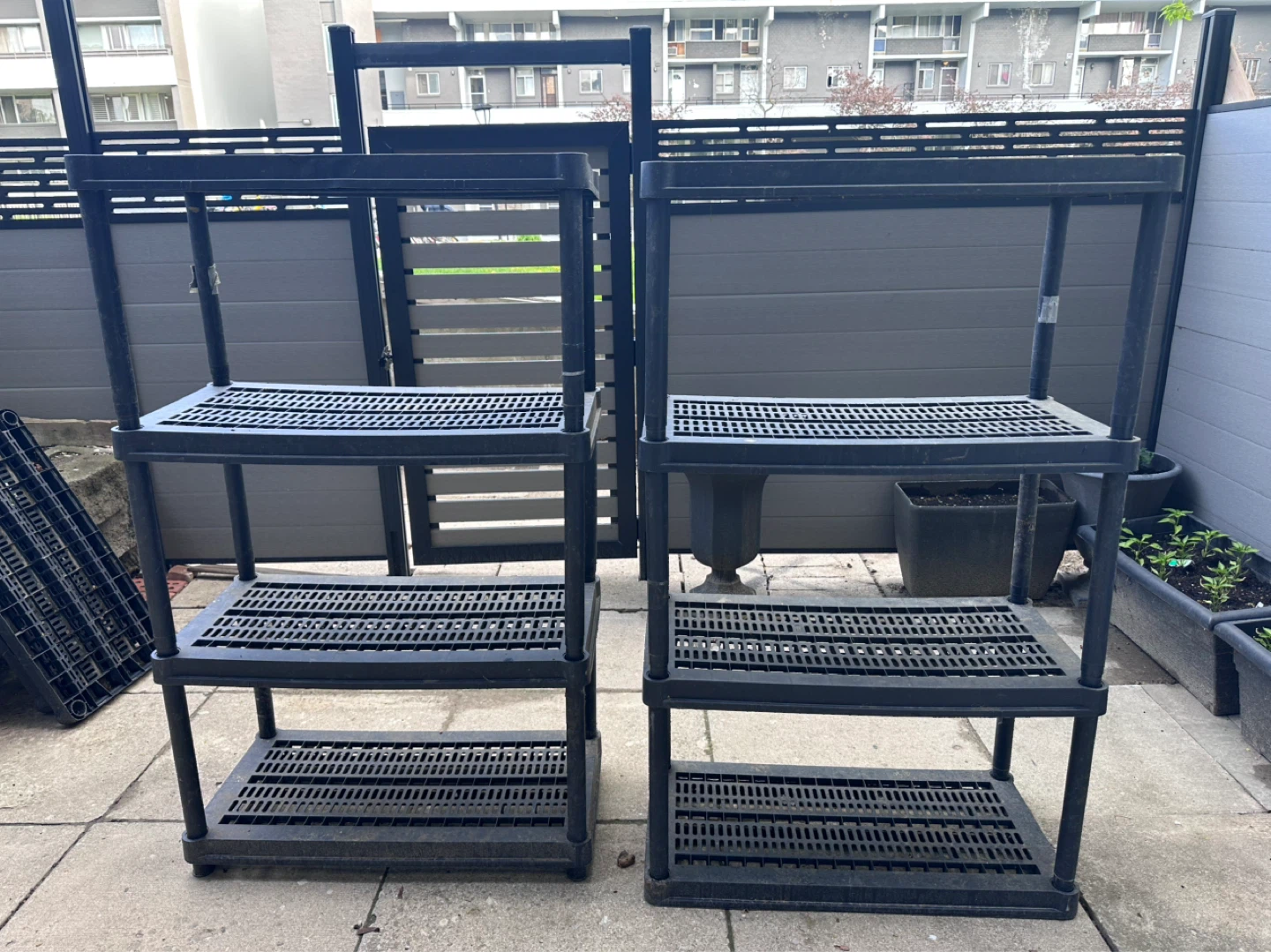 Two Black 4-Tier Plastic Shelving Units