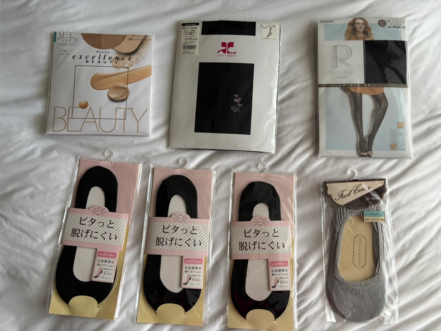 Assorted new Japanese tights and foot covers.