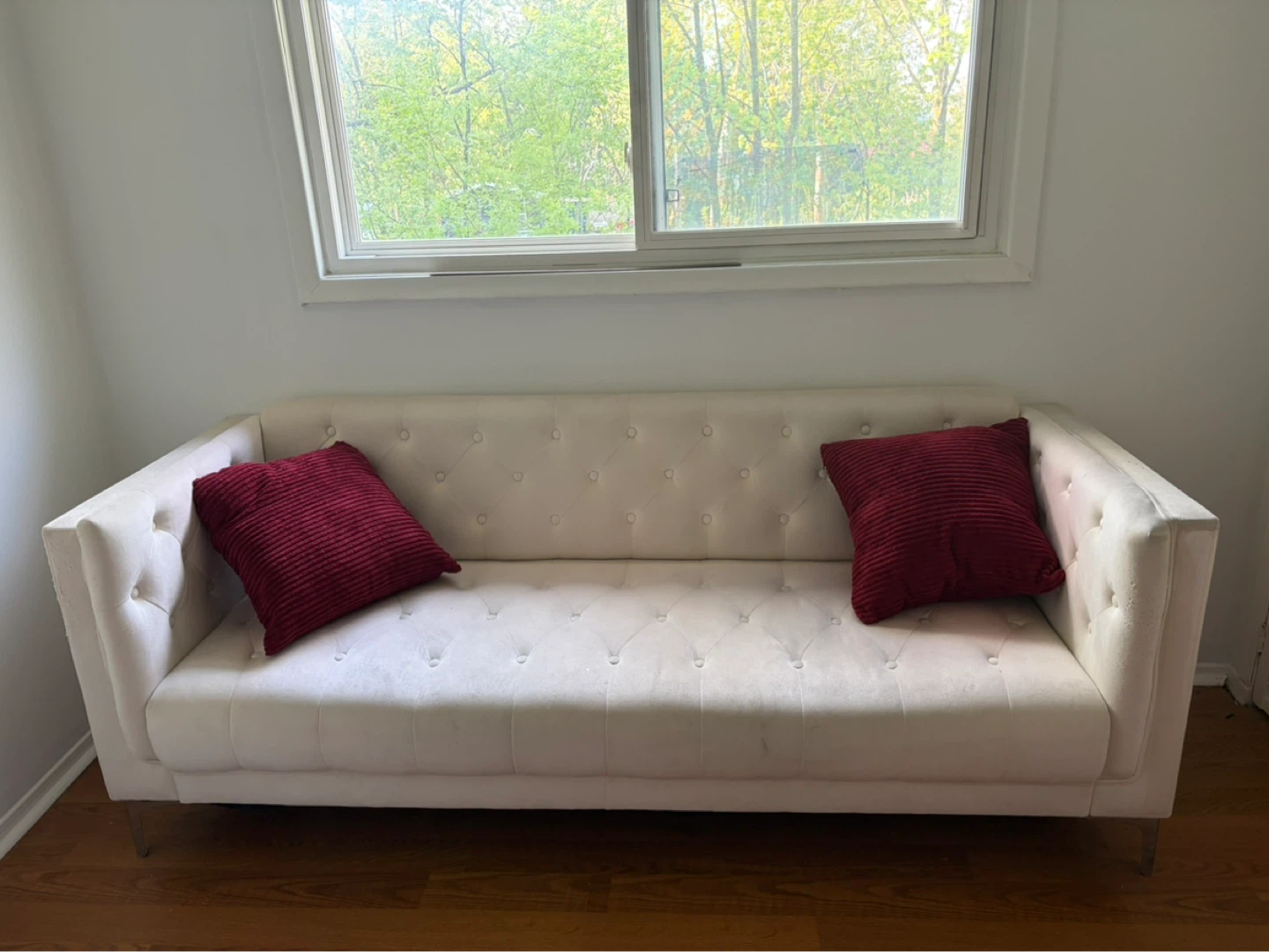 Cream Tufted Sofa with red Pillows