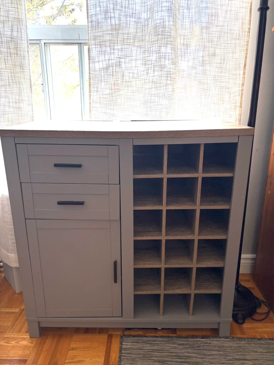 Grey storage cabinet with wine rack