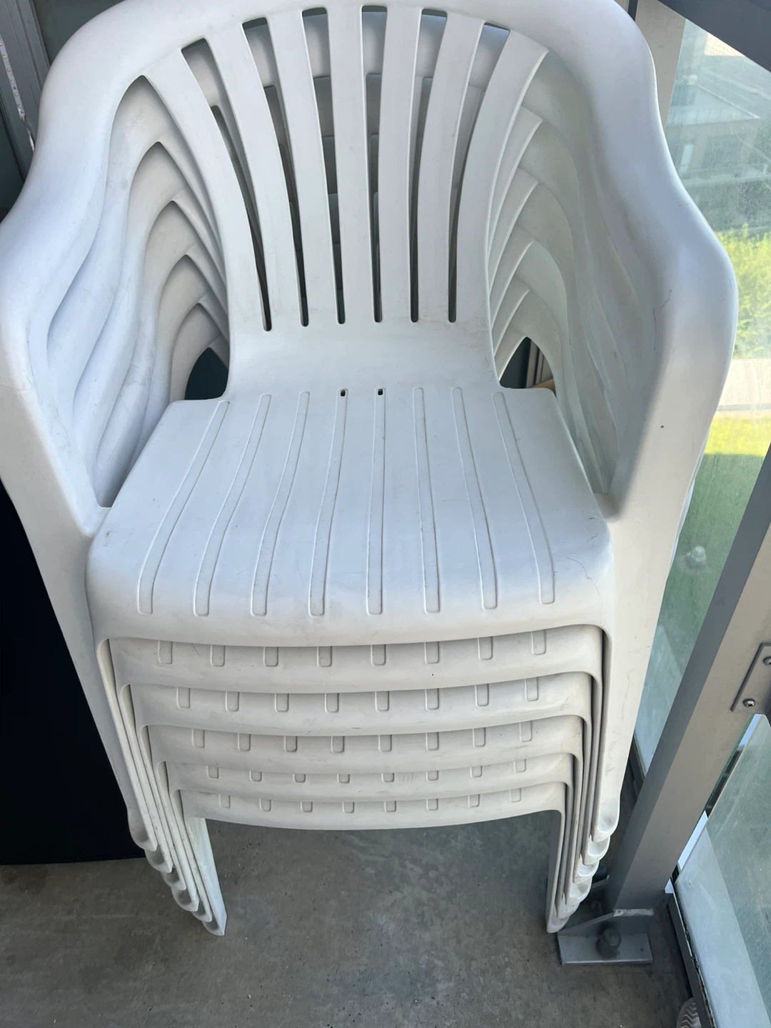 Stack of 6 White Plastic Patio Chairs
