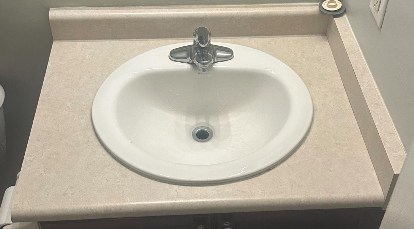 Countertop with Bathroom Sink and Chrome Faucet