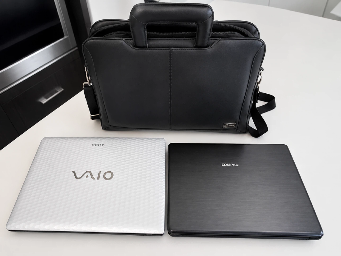 Sony VAIO and Compaq Laptops with Black Briefcase