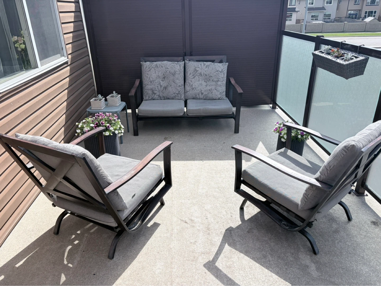 Outdoor Loveseat with Grey Cushions and chairs