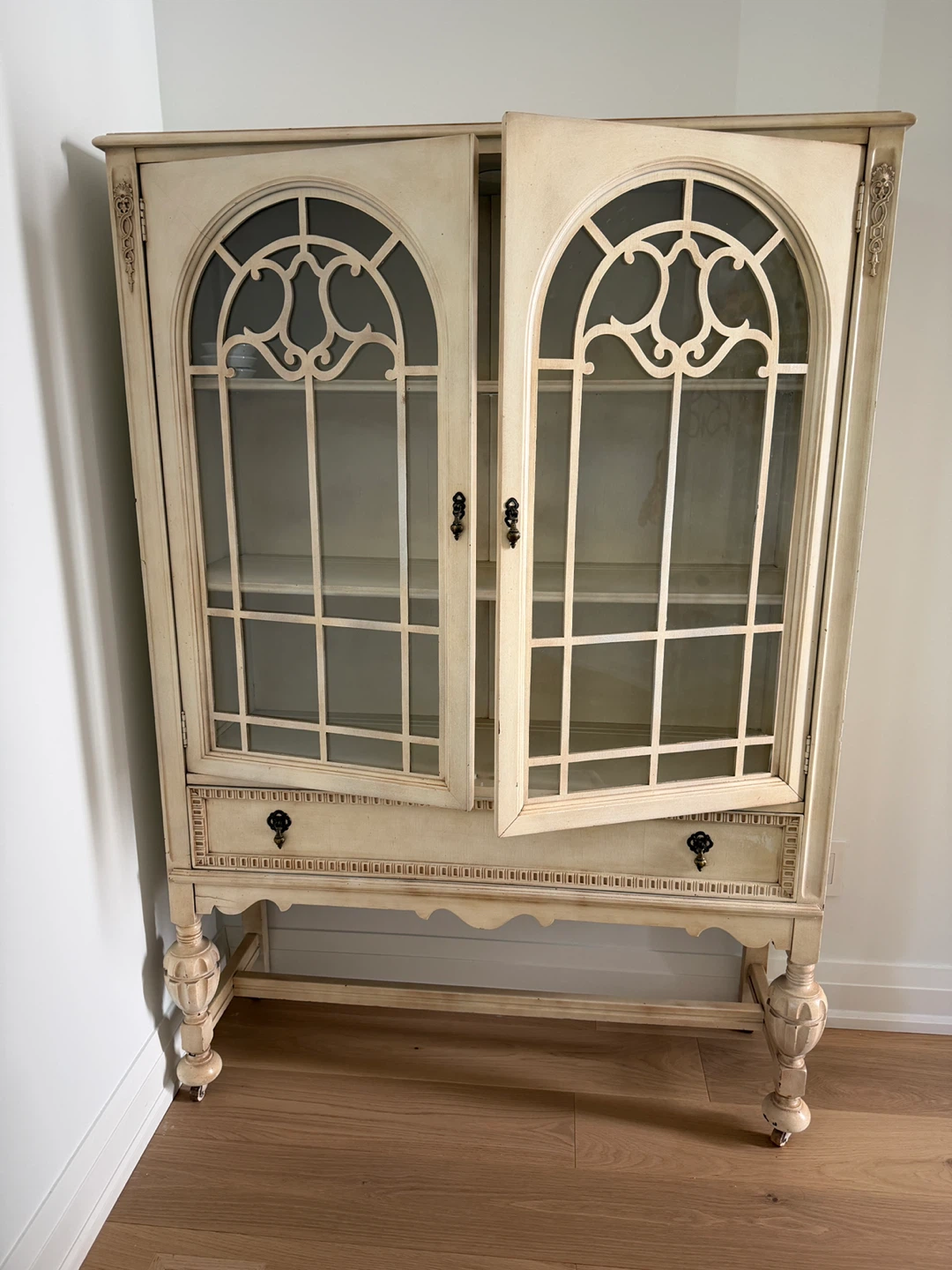 Cream Two-Door Display Cabinet with Glass Panes and Drawer