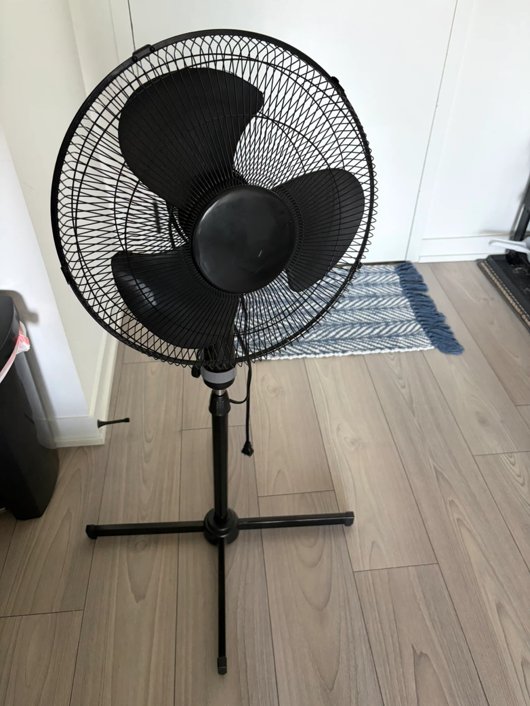 Black oscillating stand fan