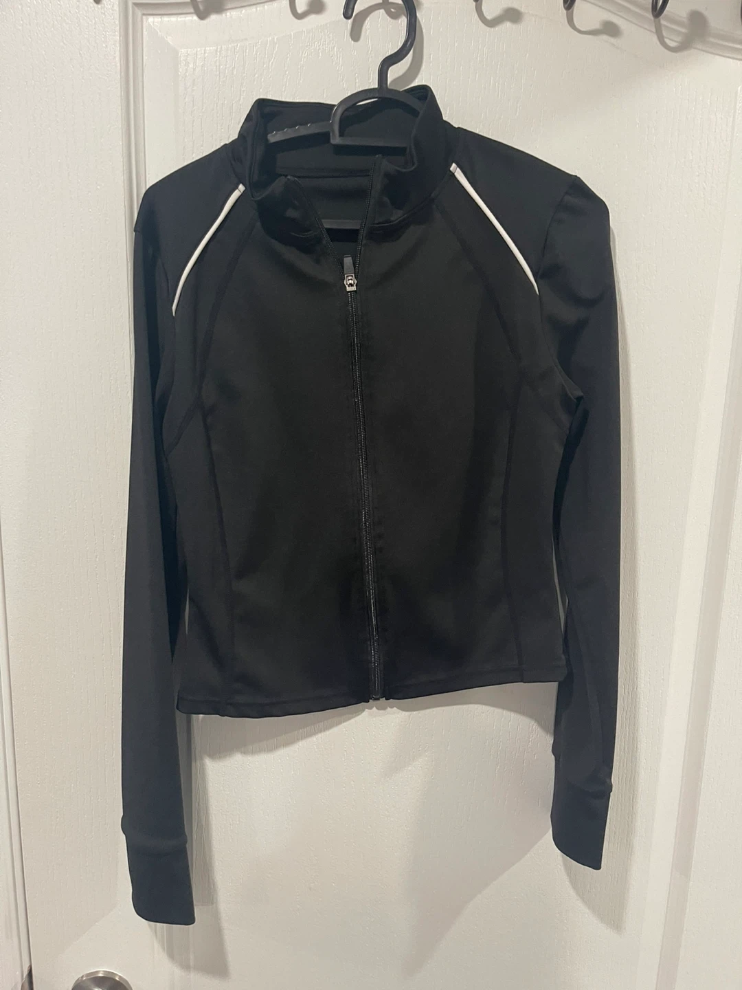 Black zip-up jacket with white piping