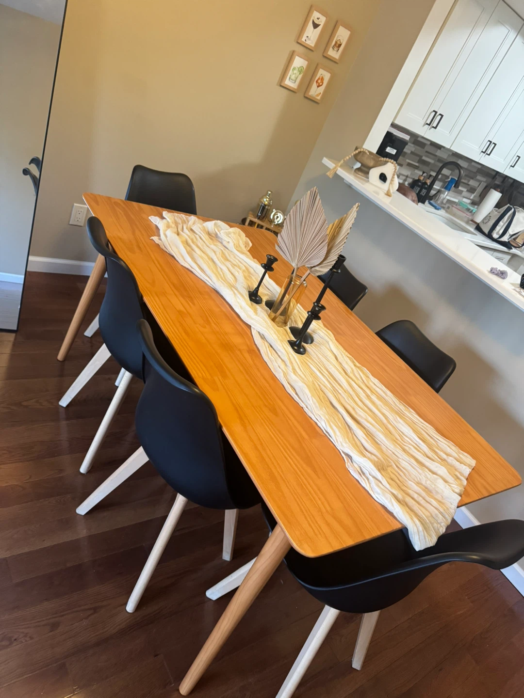 Wood Dining Table with 6 Black Chairs and Chandelier