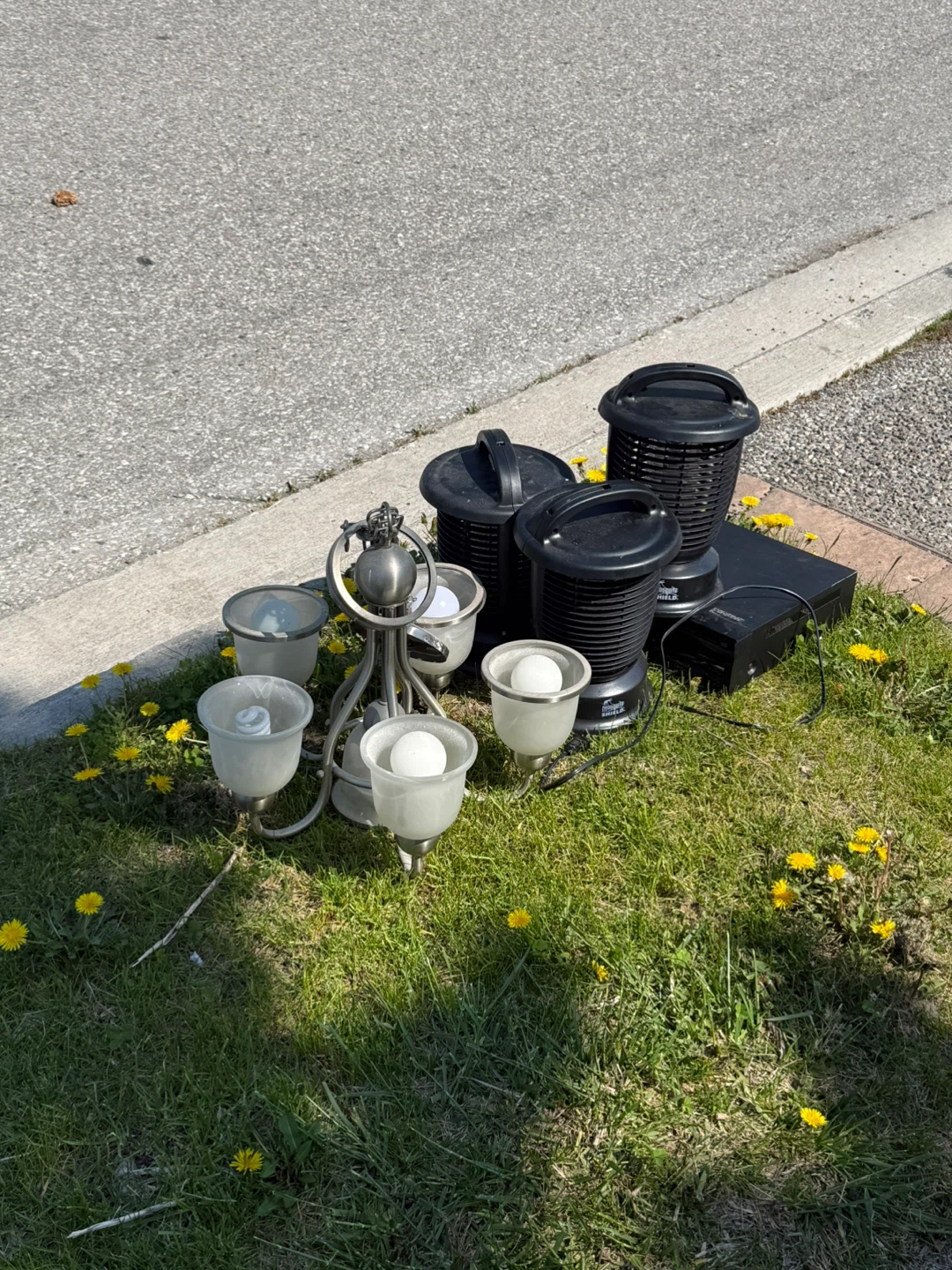 Assorted Black Outdoor Lighting Fixtures and Electronics