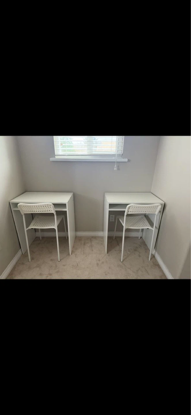 Two white IKEA desks with chairs
