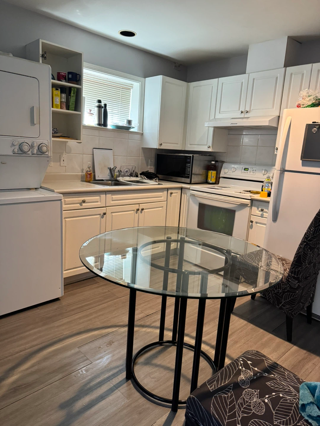 Round Glass Dining Table with Black Metal Base