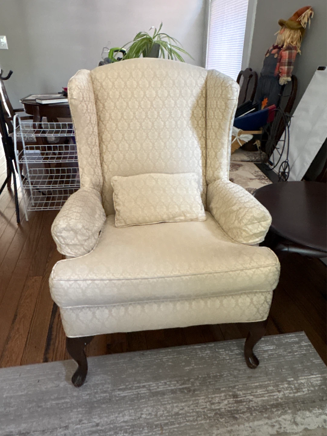 Cream Wingback Armchair with Throw Pillow