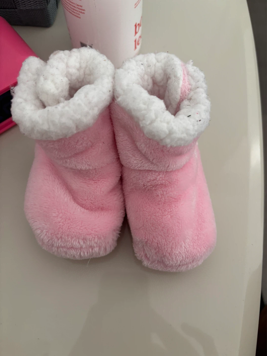 Used Pink fuzzy baby booties with grippy soles