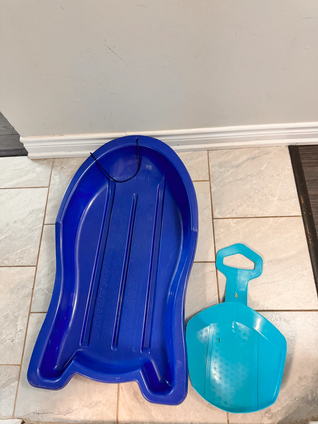 Blue Toboggan Sled and Teal Snow Saucer