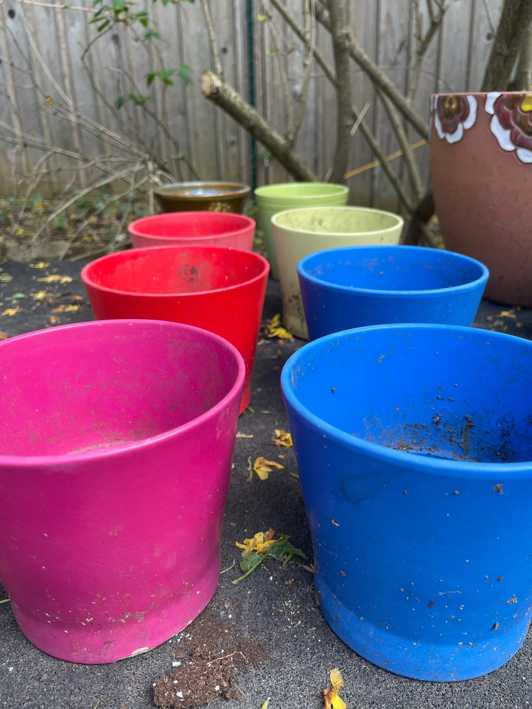 Set of 7 colourful plant pots with holes