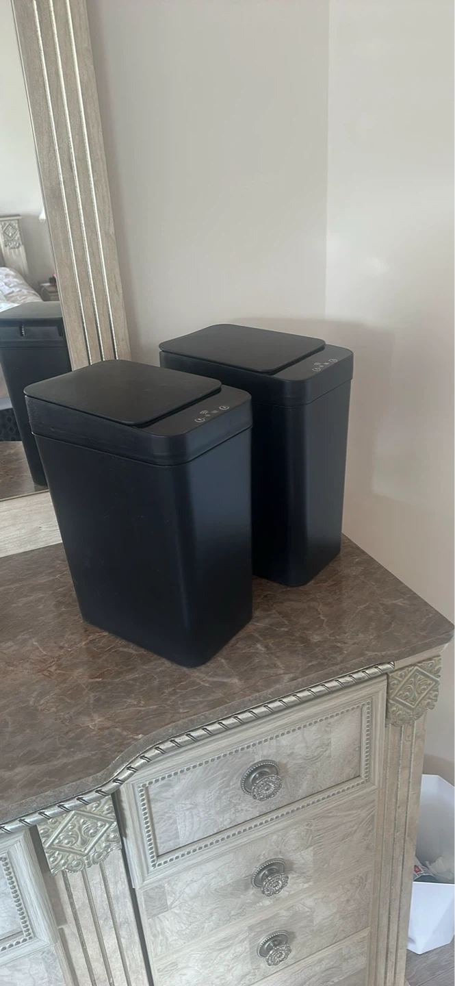 Two Black Automatic Trash Cans