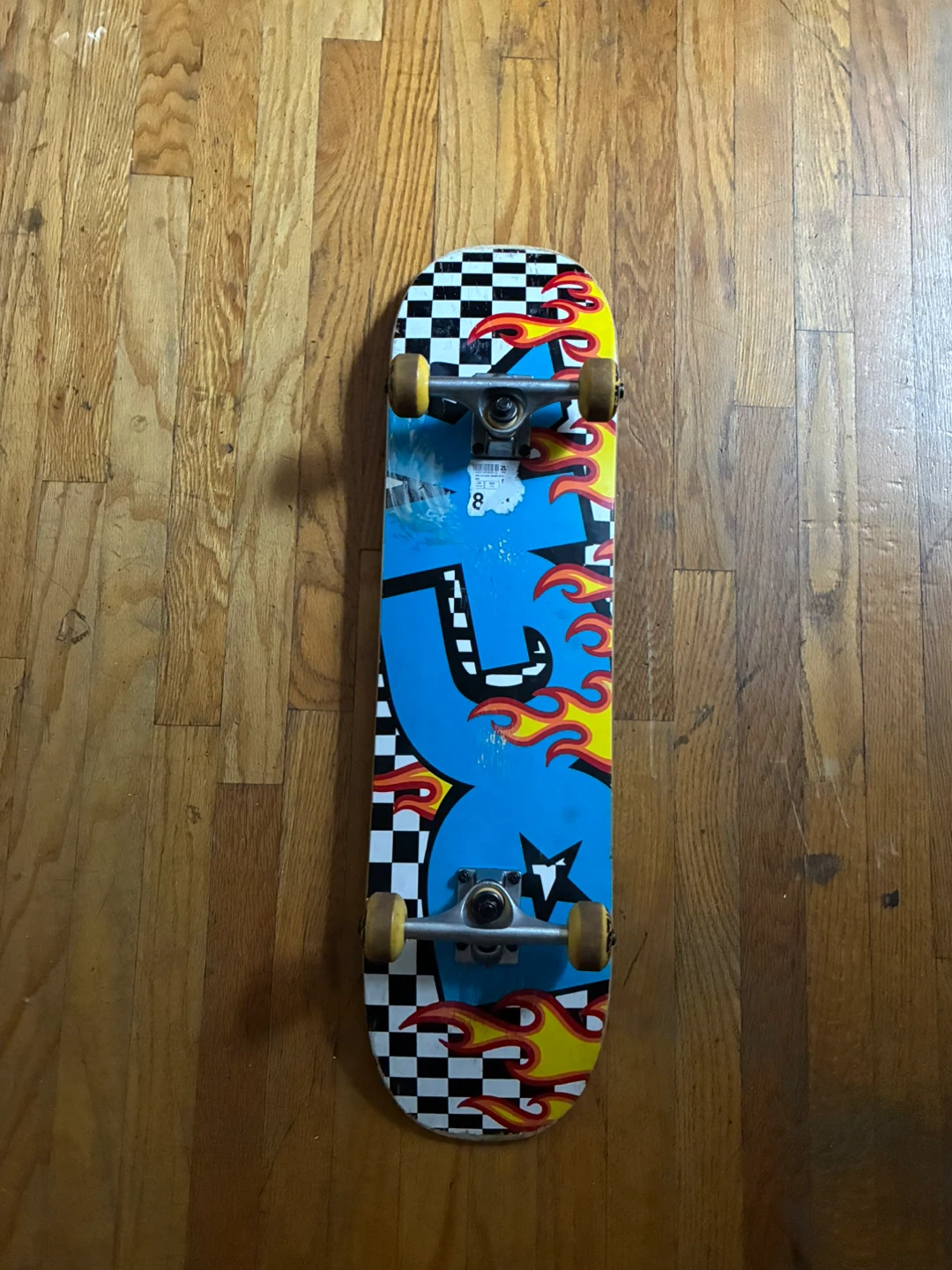 Skateboard with Flame and Checkerboard Design