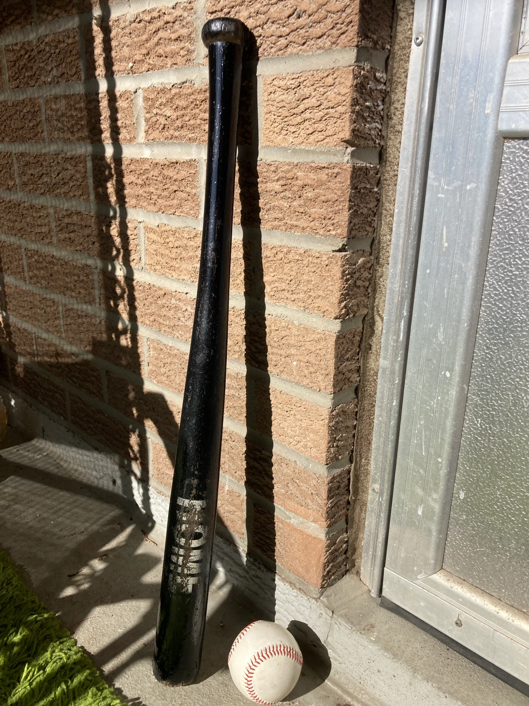 Black Wooden Baseball Bat with Baseball