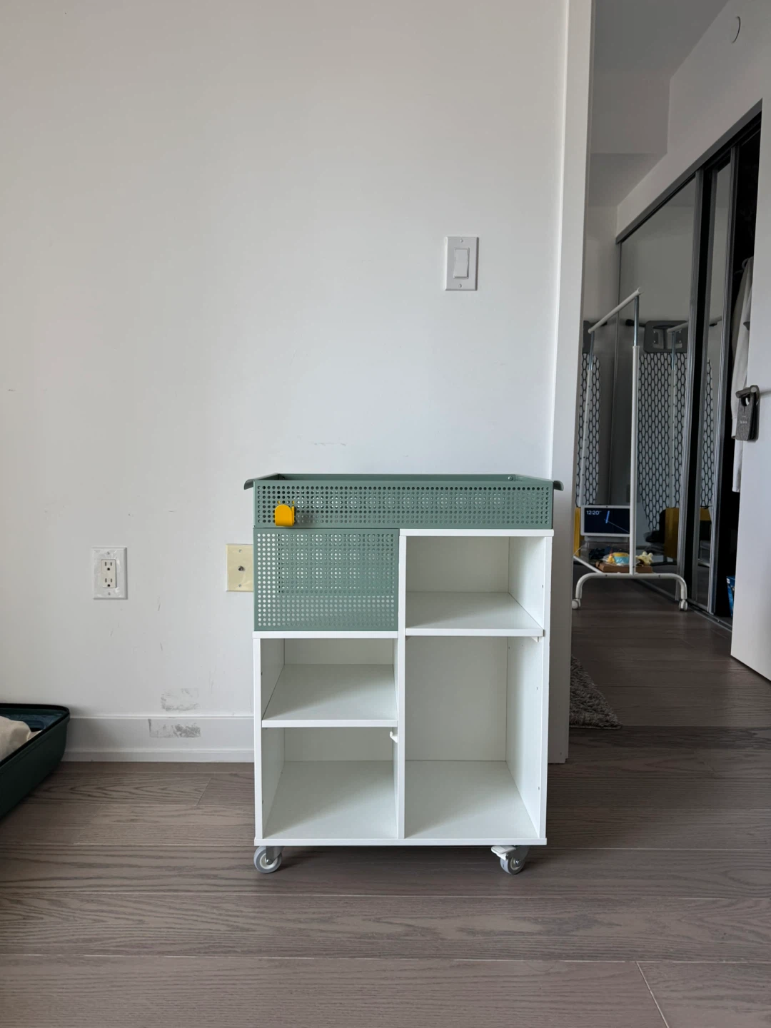 Green and white rolling storage cart