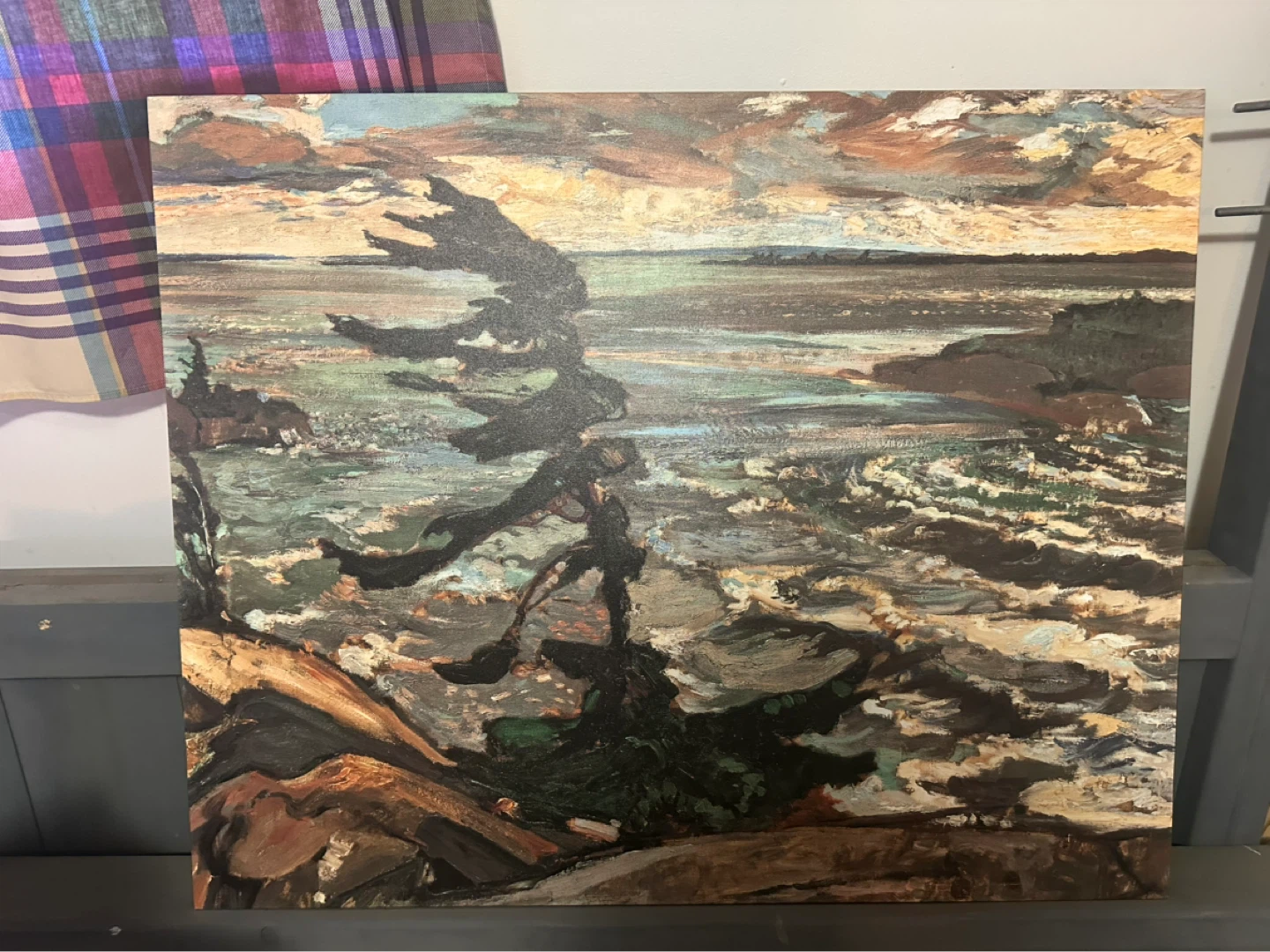 Painting of a windswept tree and rocky shore
