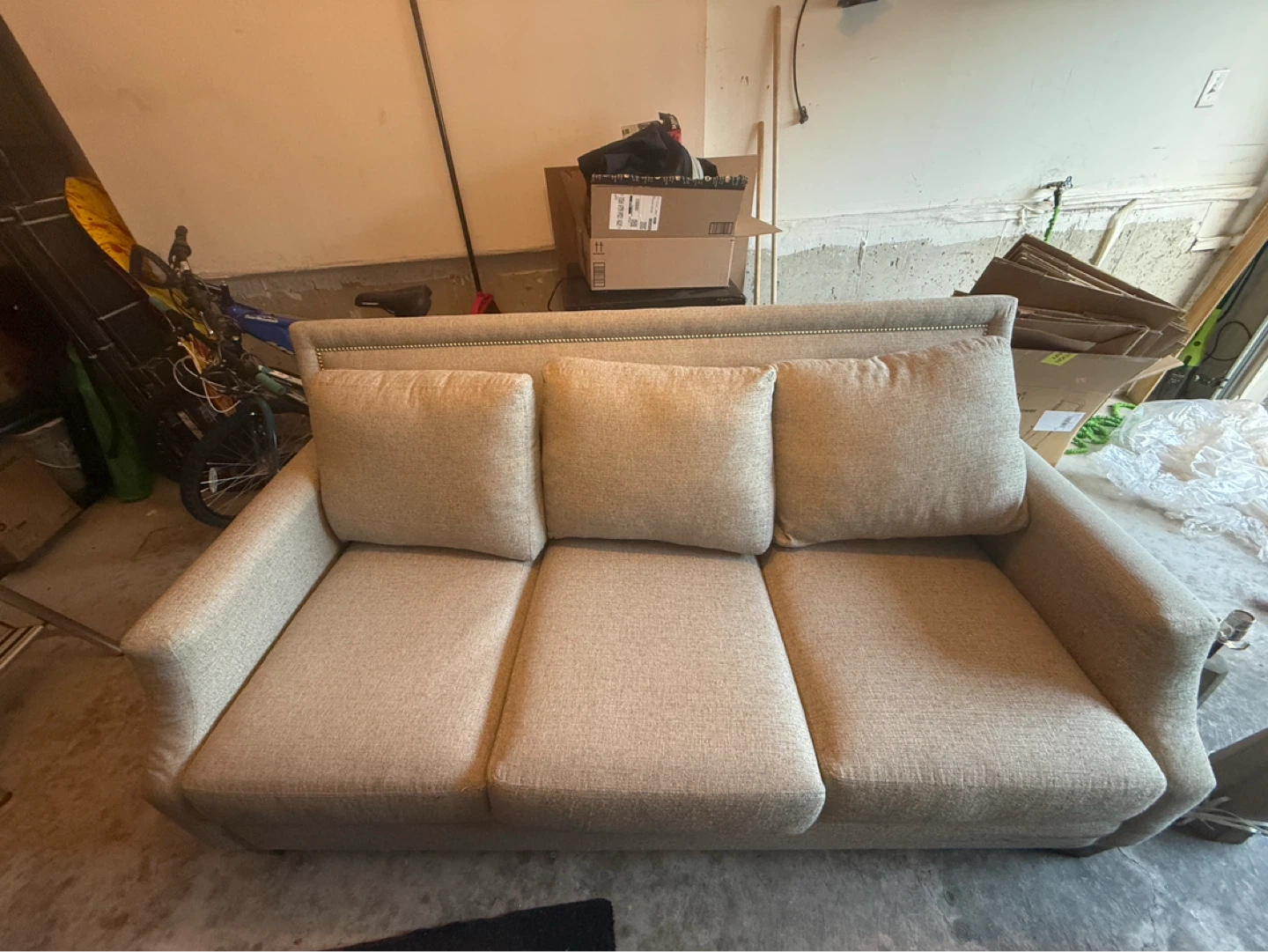 Three-seater couch with decorative studs
