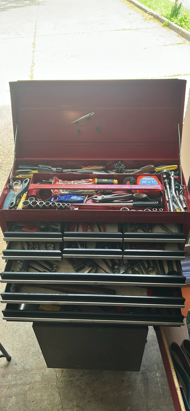 Red Metal Toolbox Filled with Assorted Tools