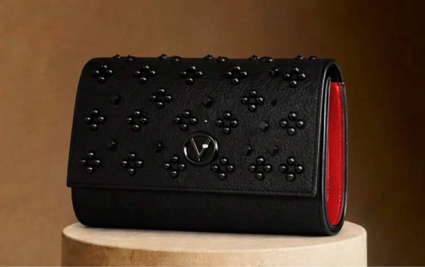 Black rivet embellished evening clutch with chain strap
