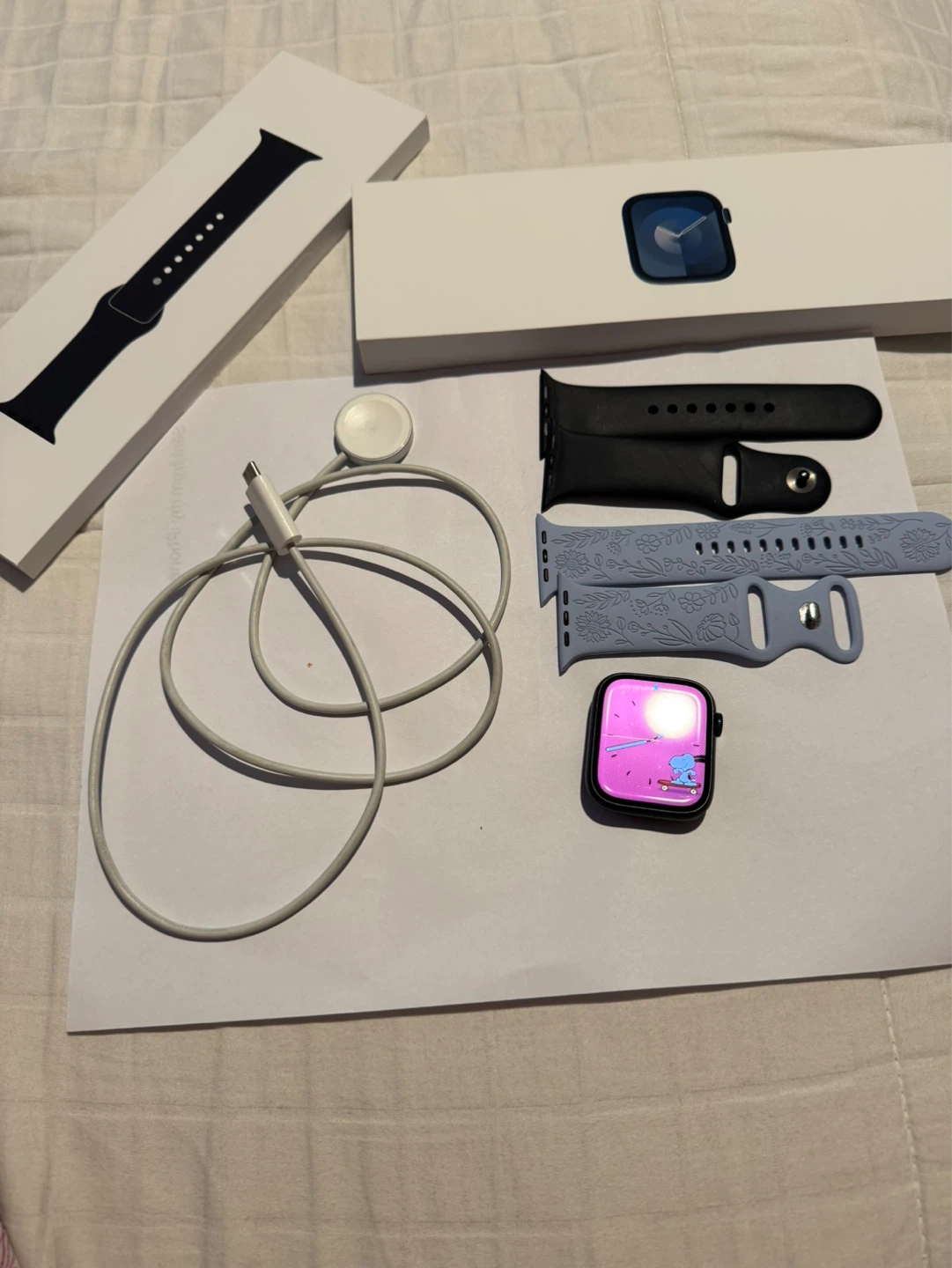 Apple Watch Series 7 with bands and charger
