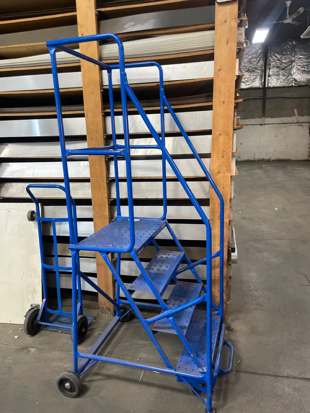 Blue rolling step ladder