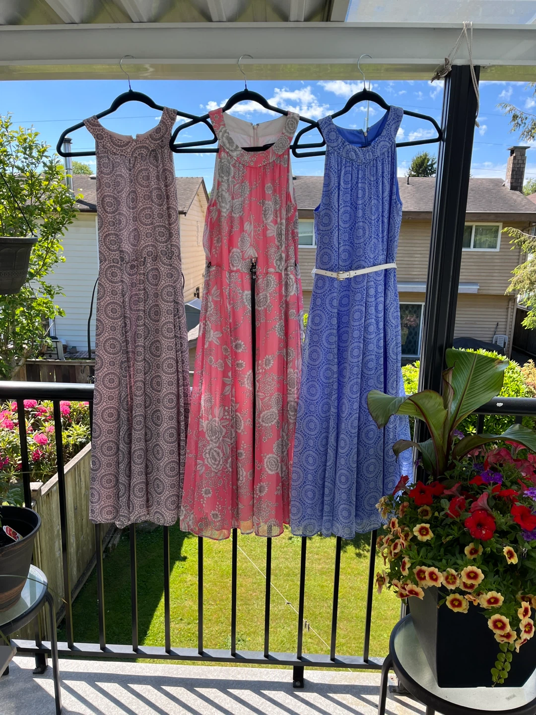 Three women's sleeveless print dresses