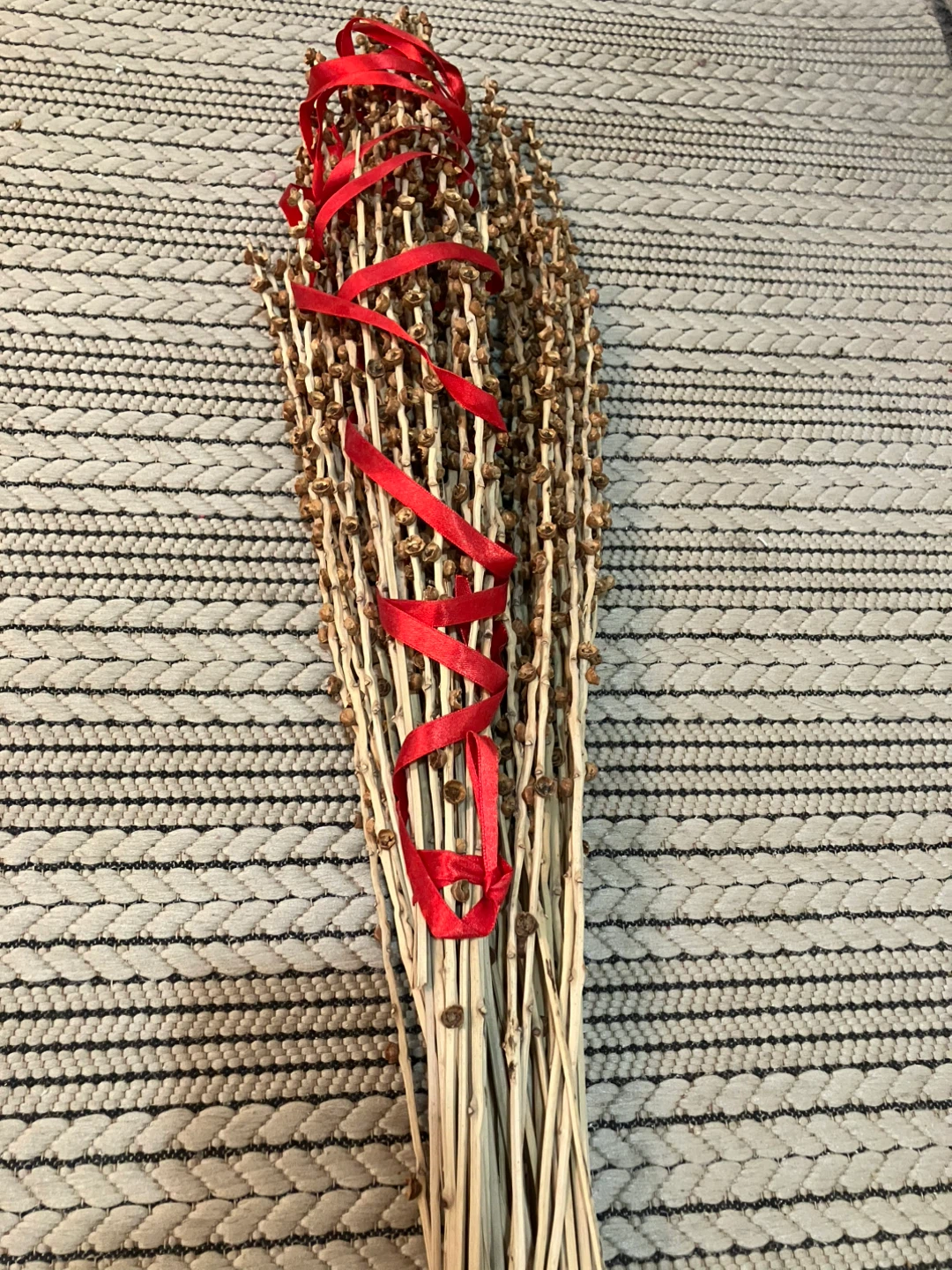 Dried floral arrangement with red ribbon