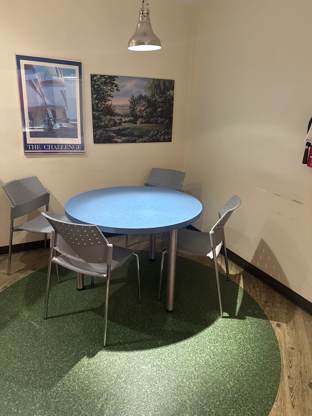 Round blue table with 4 grey chairs