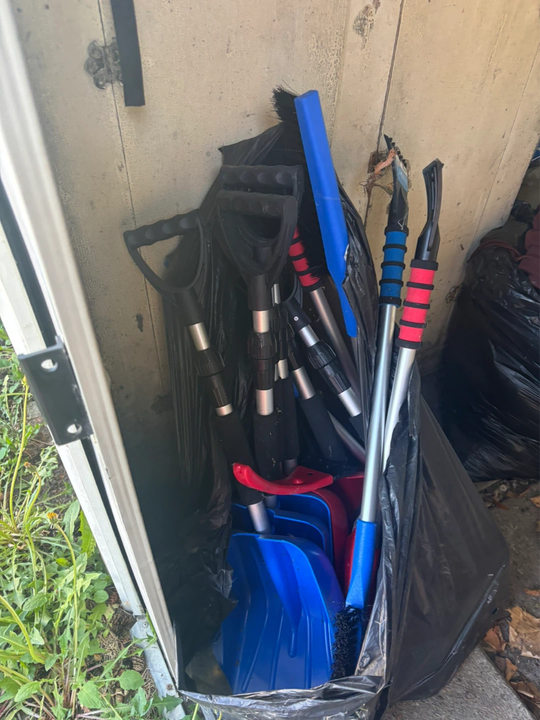 Lot of Snow Brushes and Small Snow Shovels