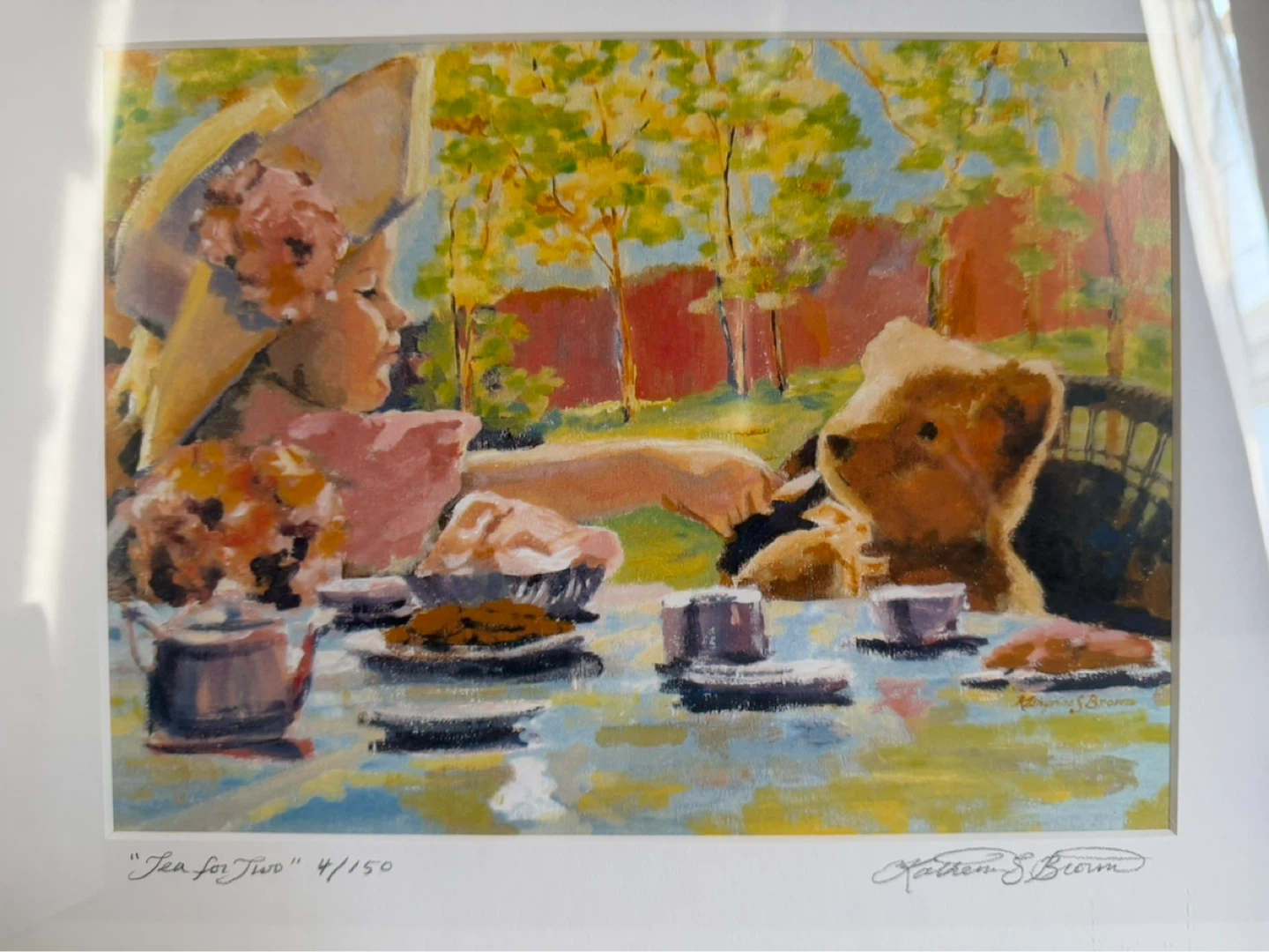 Girl and teddy bear having a tea party
