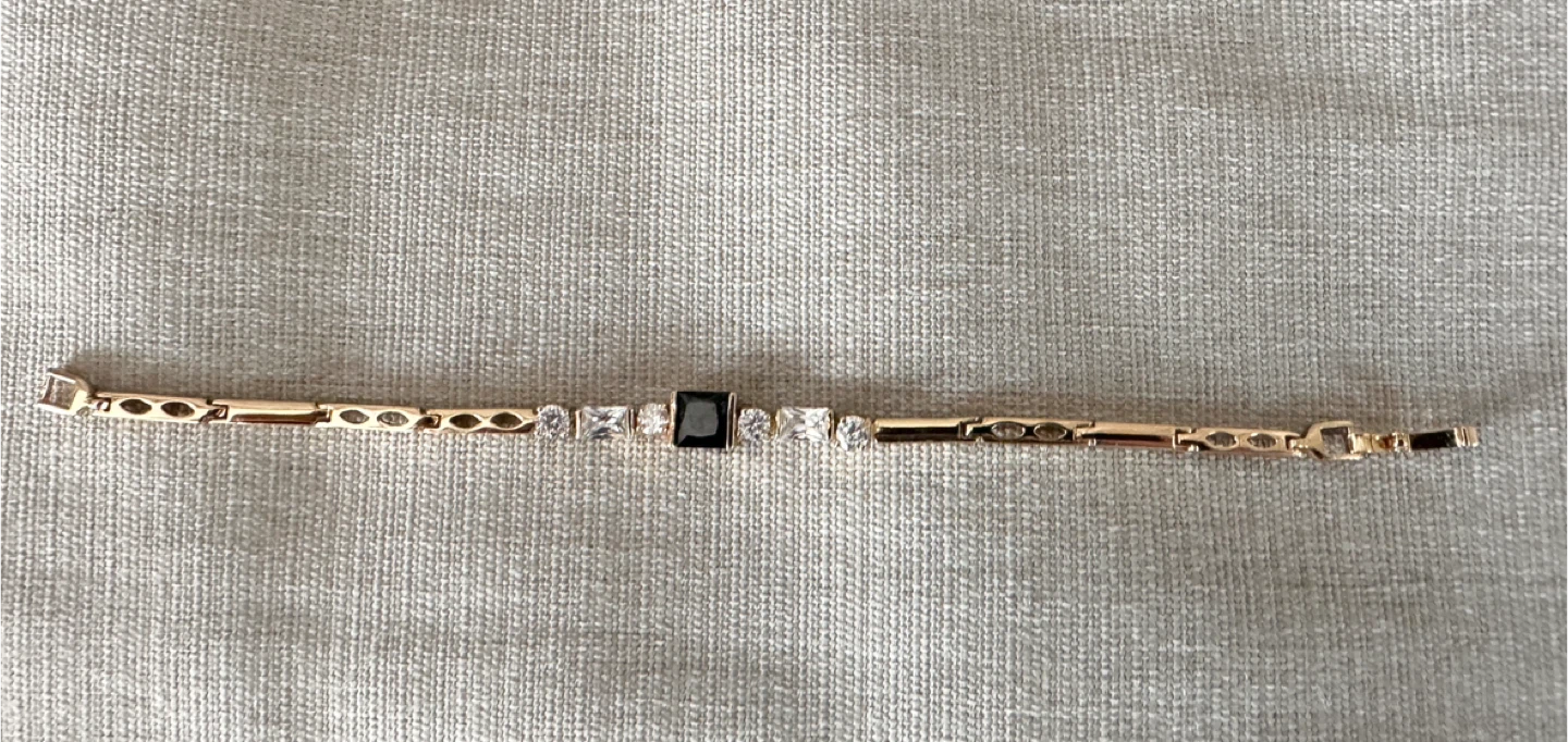 Gold-tone bracelet with black and clear stones