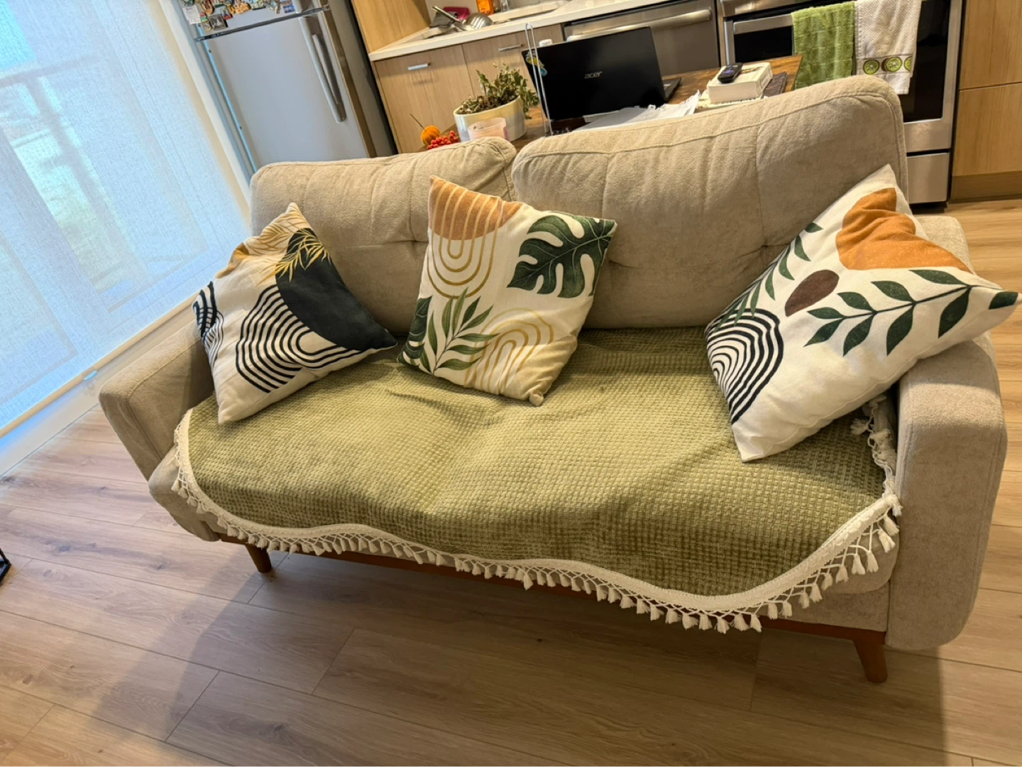 Beige loveseat sofa with decorative pillows
