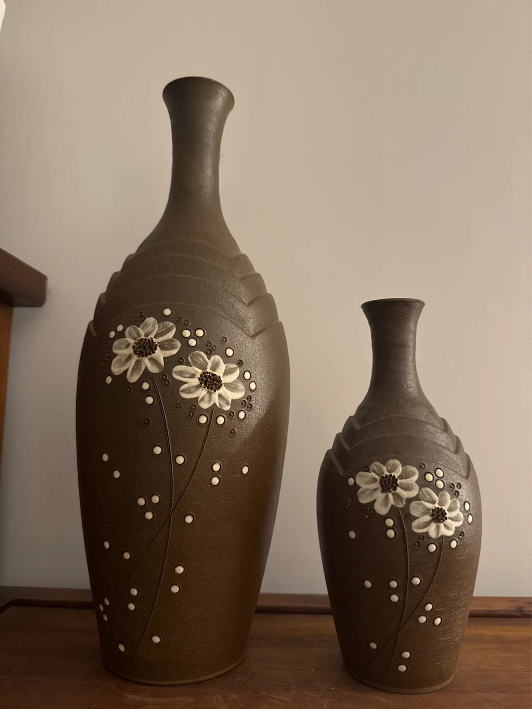 Two brown ceramic vases with floral design