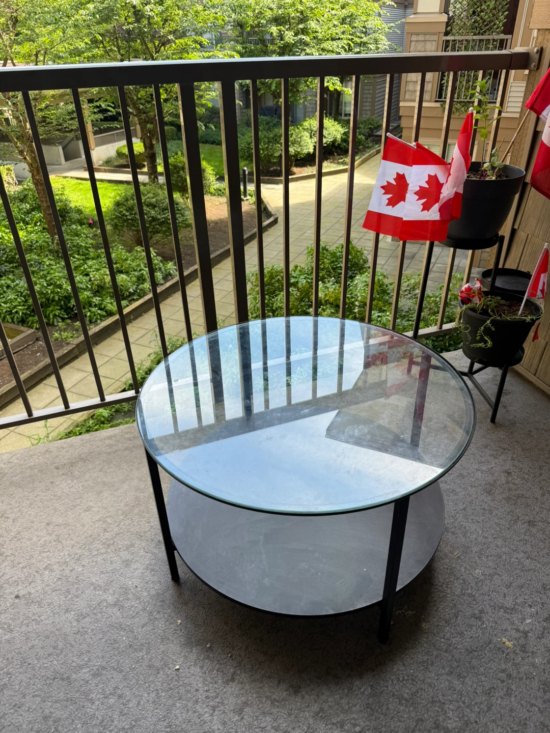 Glass top coffee table with lower shelf