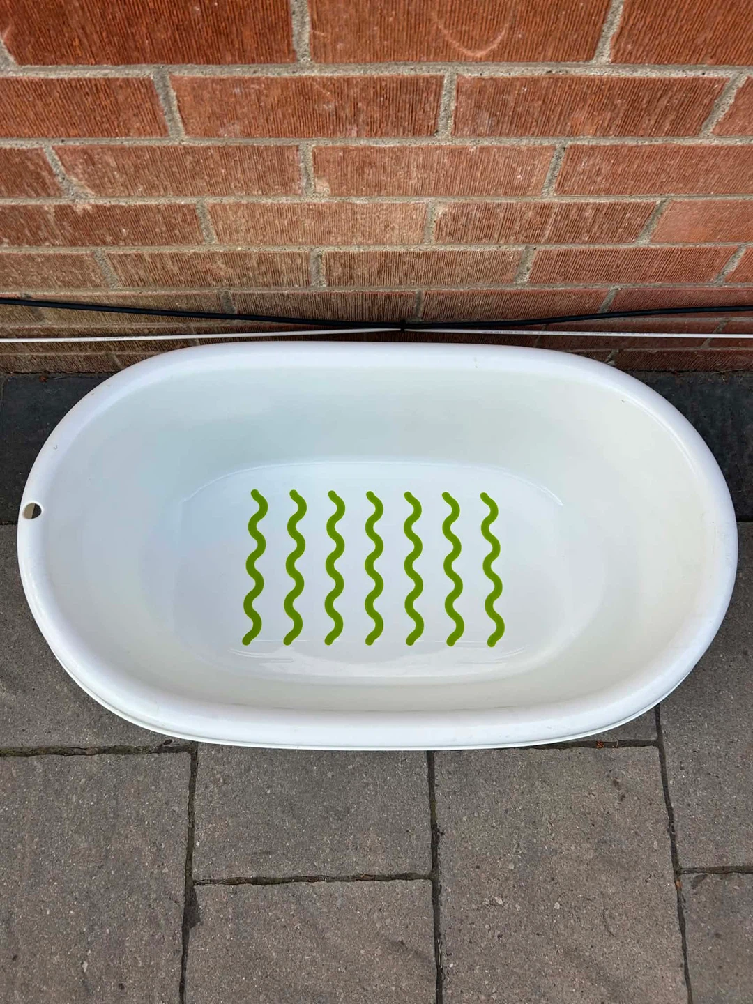 White Baby Bathtub with Green Grips