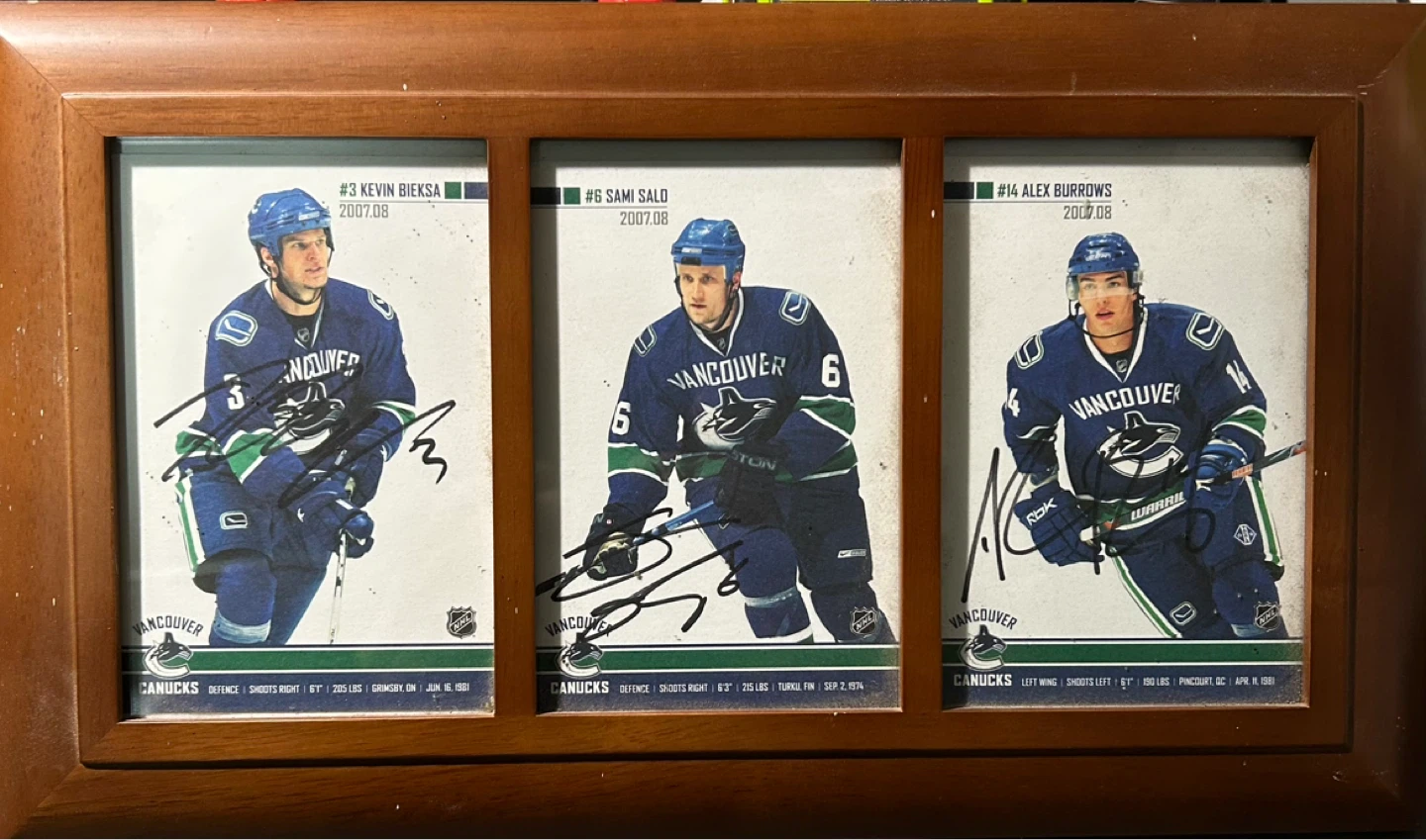 - Framed signed photos of Bieksa, Salo and Burrow