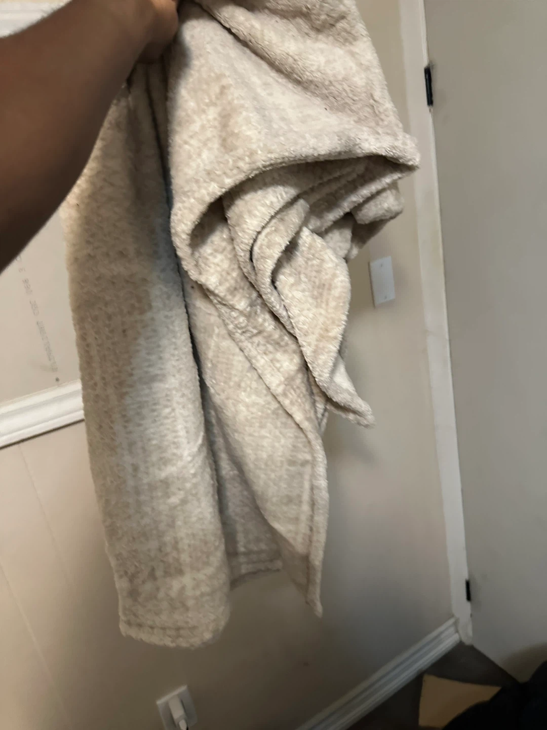 Black Puffer Jacket and Cream Fleece Blanket