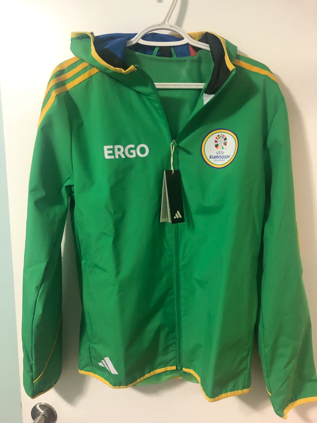 Waterproof ADIDAS jacket with hoodie and green backpack