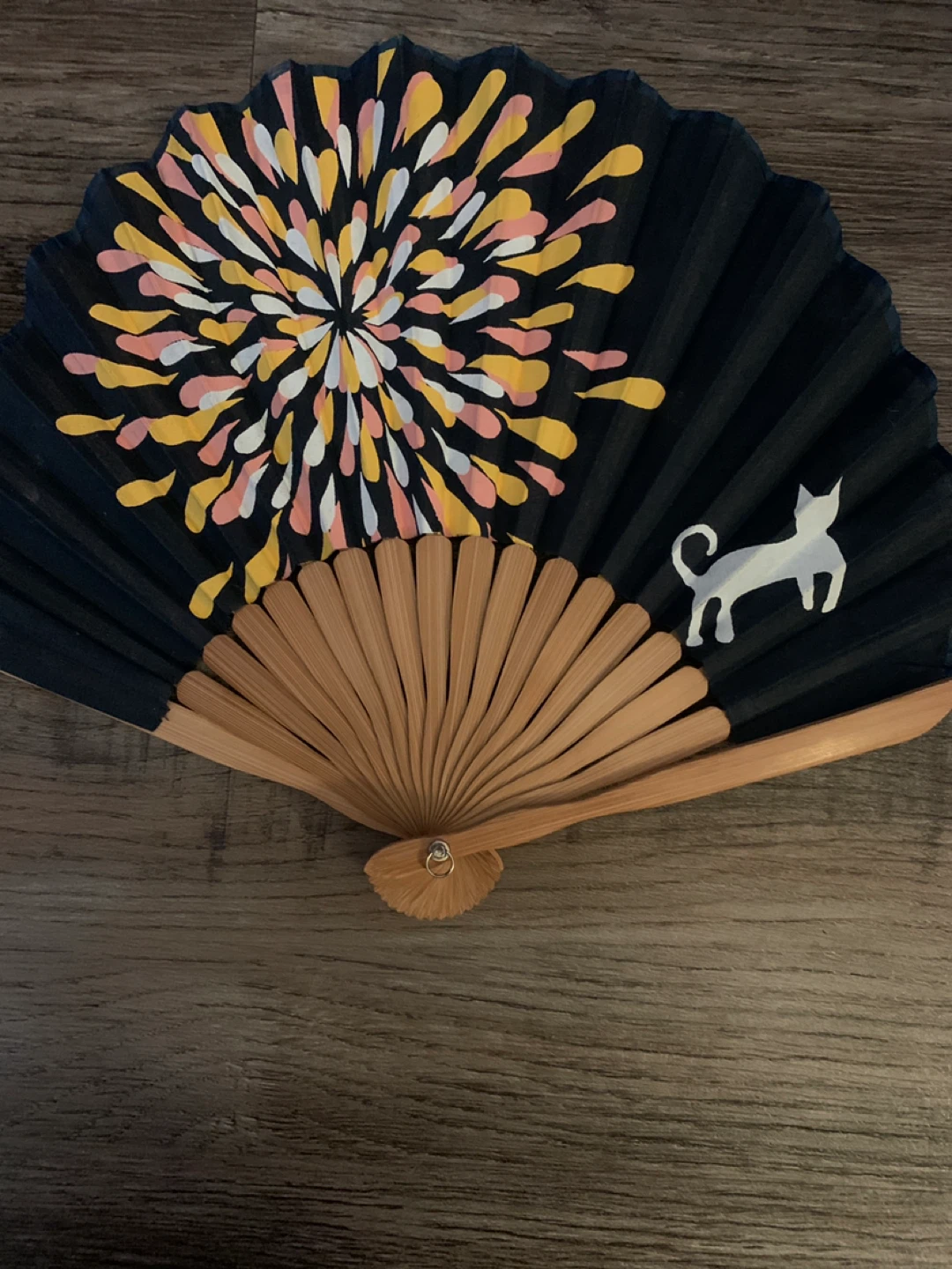 Black fan with fireworks and cat design