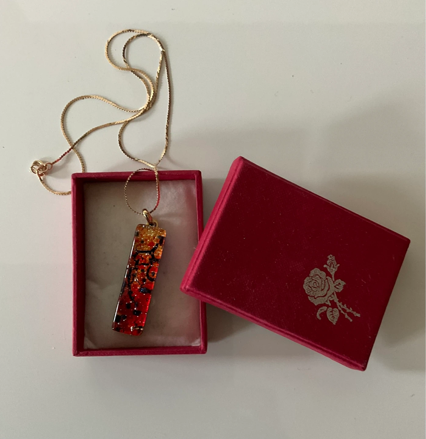 10k gold chain necklace with red and gold abstract pendant