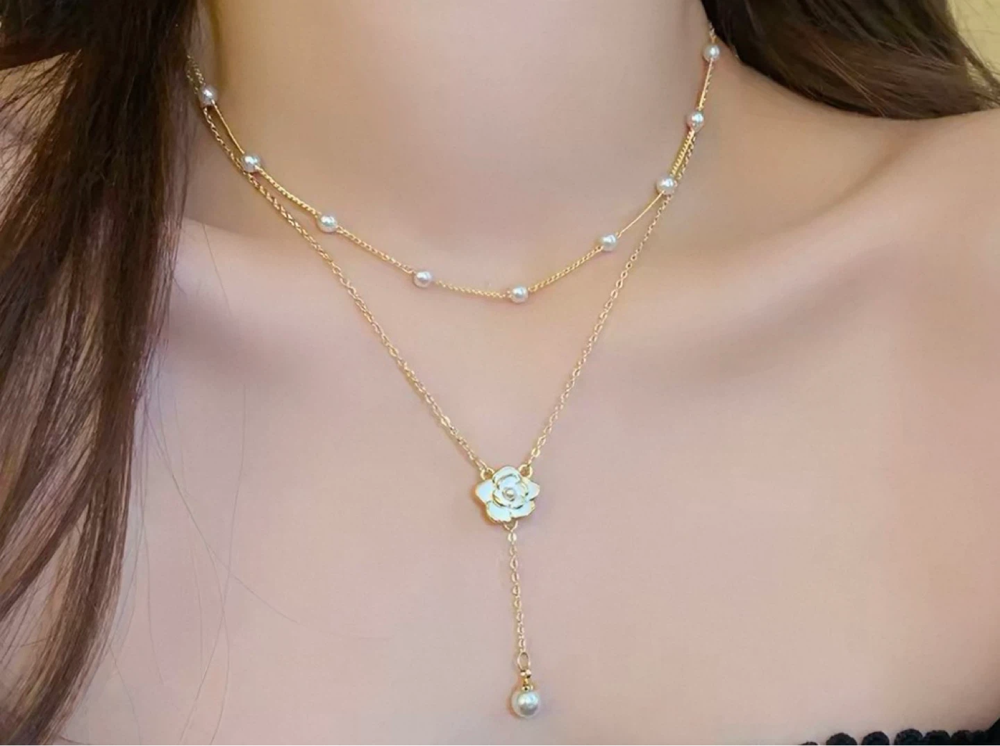 Gold layered necklace with pearl accents and flower pendant