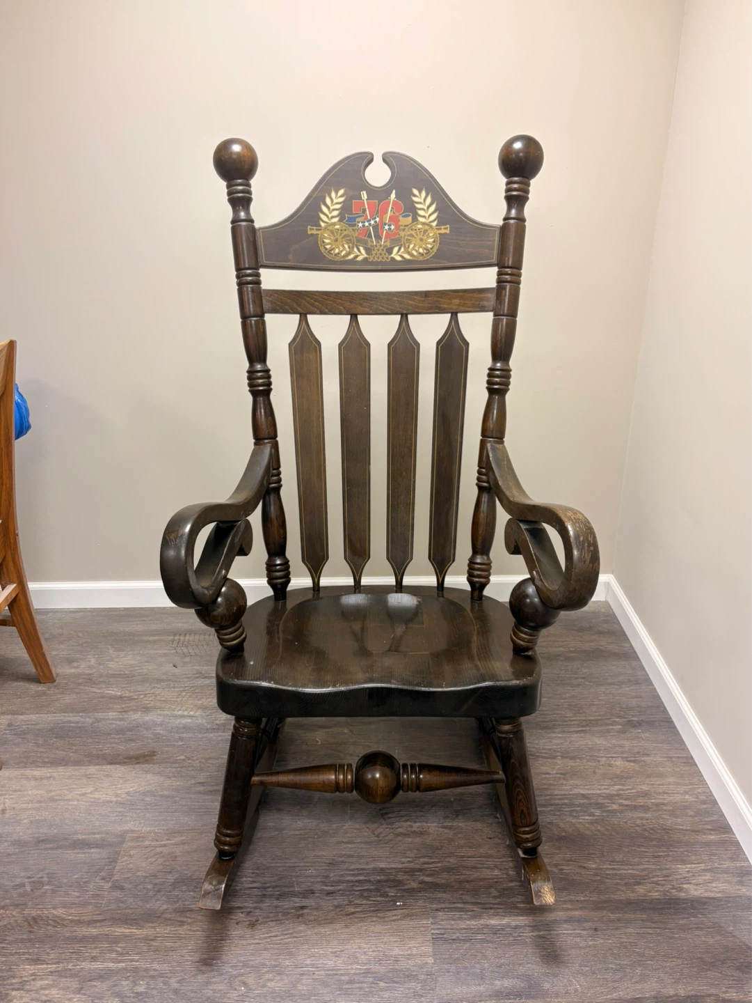 Antique Wooden Rocking Chair with Decorative Emblem