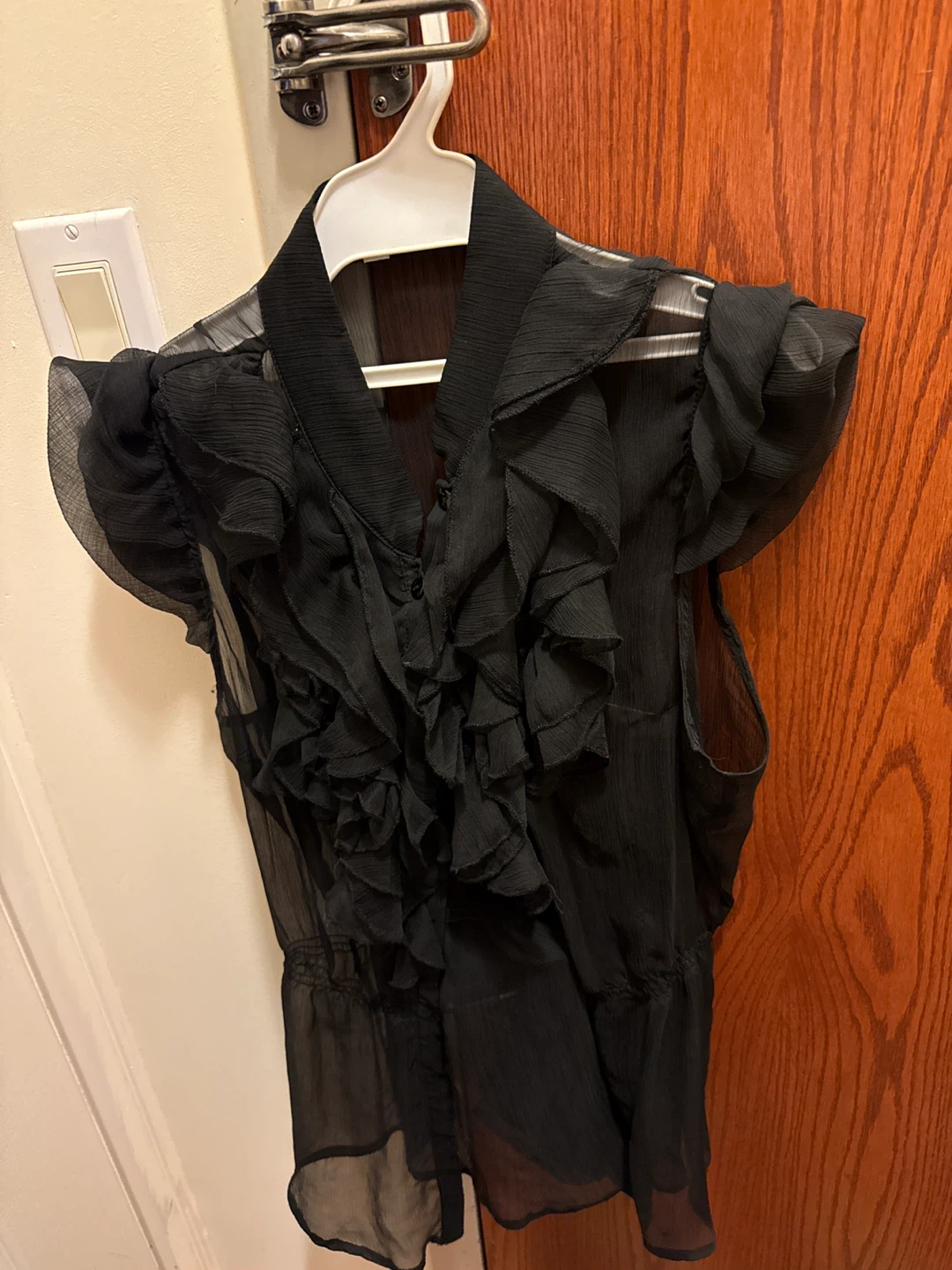 Black sheer ruffled sleeveless blouse