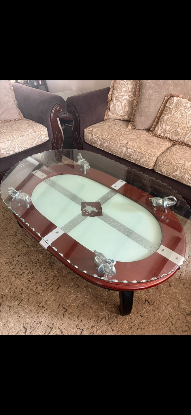 Glass coffee table with decorative elephants